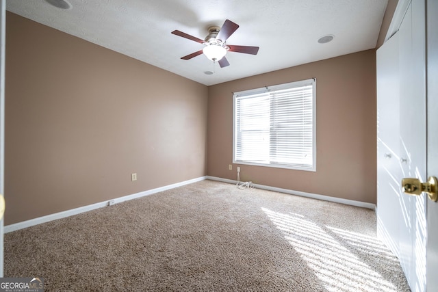 carpeted empty room with ceiling fan