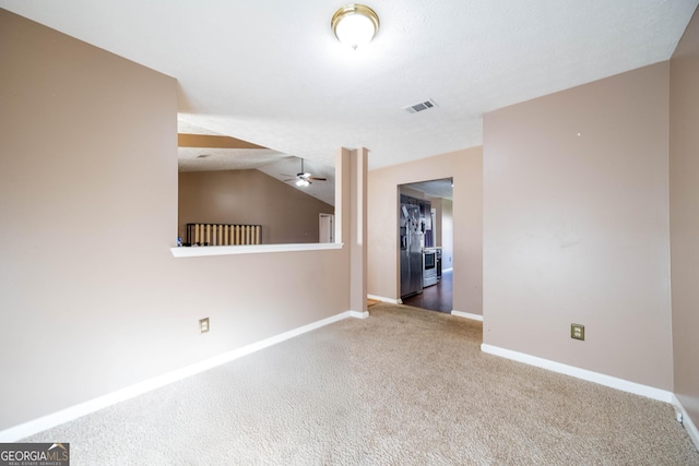 unfurnished room featuring lofted ceiling, carpet floors, and ceiling fan