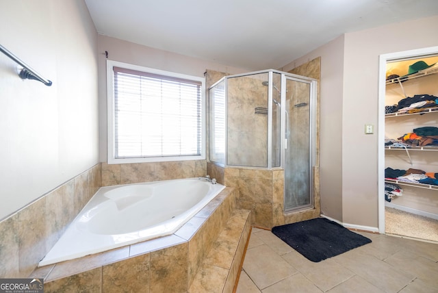 bathroom with tile patterned flooring and shower with separate bathtub