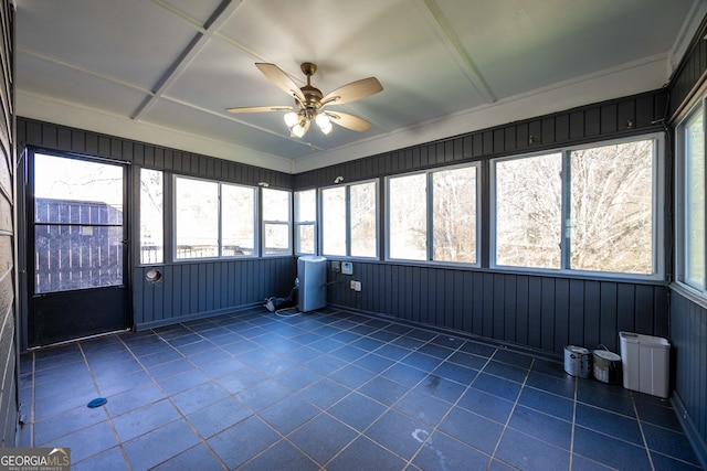 unfurnished sunroom with ceiling fan