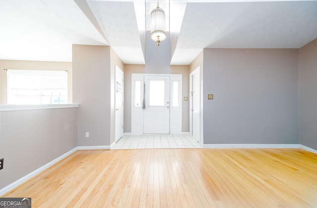 entryway featuring hardwood / wood-style floors and a textured ceiling