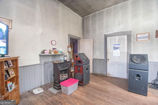 misc room with hardwood / wood-style flooring and a high ceiling