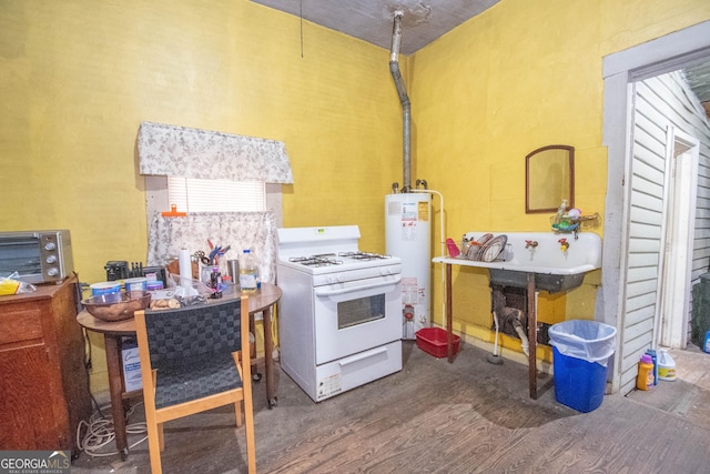 kitchen with white gas stove, hardwood / wood-style floors, and gas water heater