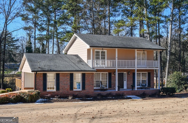 view of front of property featuring a balcony and covered porch