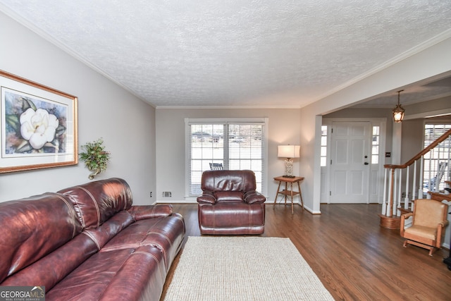 living area featuring dark wood-type flooring, stairway, plenty of natural light, and crown molding