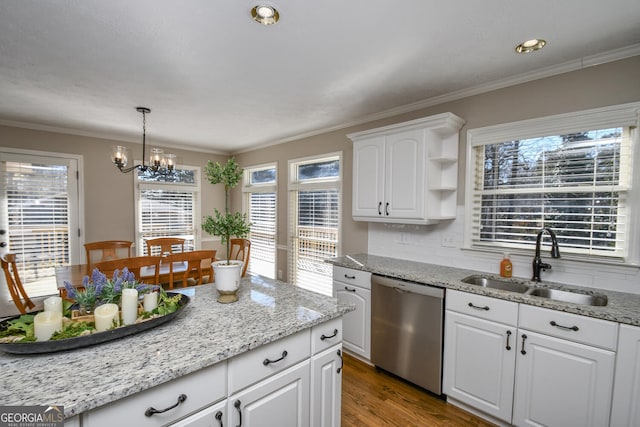 kitchen with white cabinets, dishwasher, ornamental molding, wood finished floors, and a sink