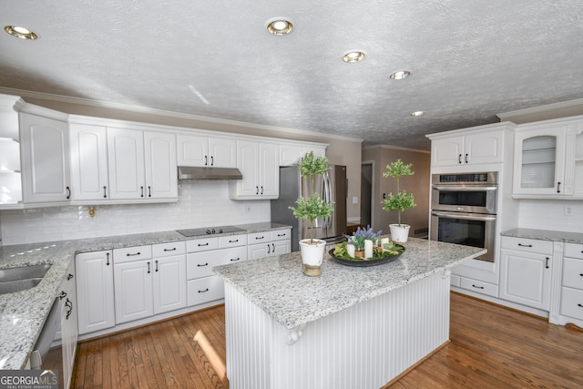 kitchen with stainless steel appliances, white cabinetry, under cabinet range hood, and dark wood-style floors