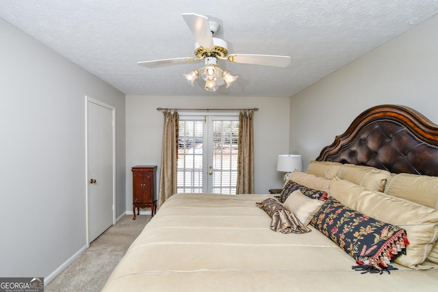 bedroom featuring a ceiling fan, light colored carpet, a textured ceiling, and baseboards