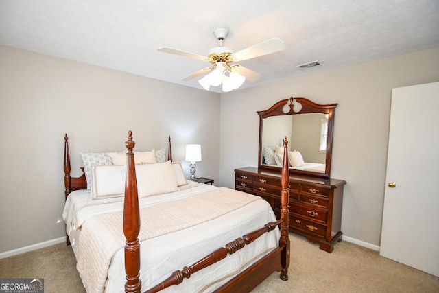 bedroom featuring visible vents, ceiling fan, light carpet, and baseboards