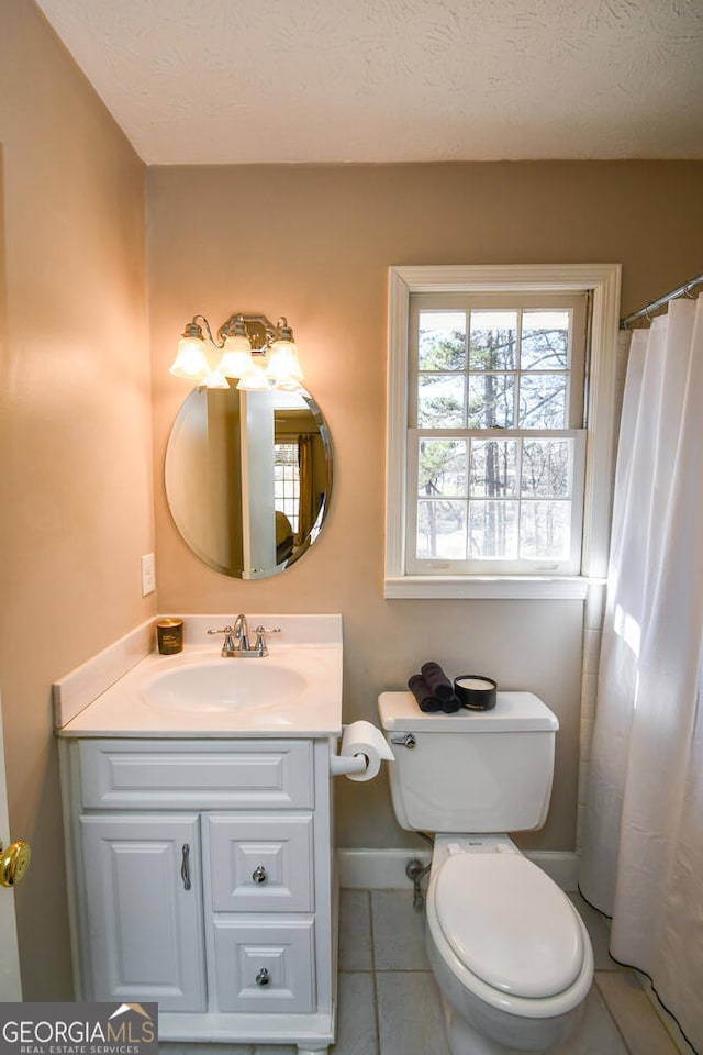 full bath featuring baseboards, toilet, tile patterned floors, a textured ceiling, and vanity