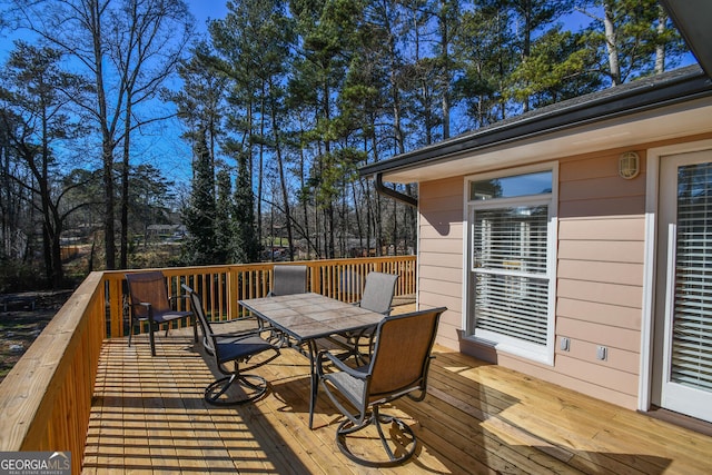 deck with outdoor dining area