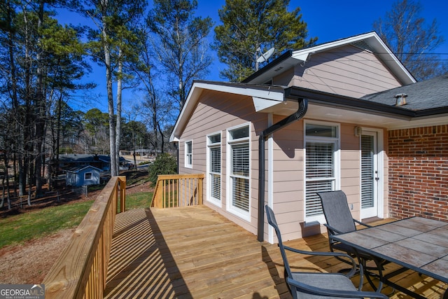 wooden terrace featuring outdoor dining area