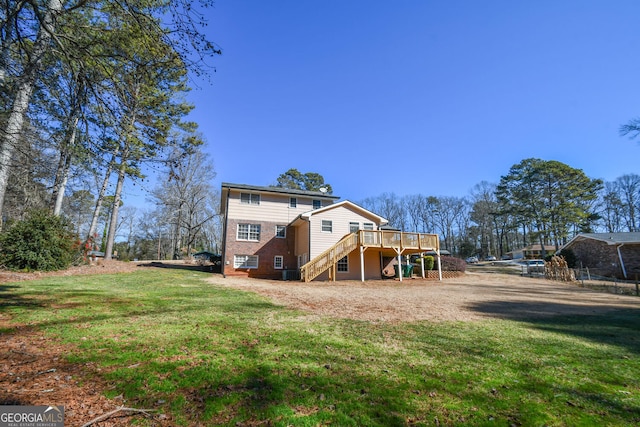 back of property featuring a lawn, stairway, and a wooden deck