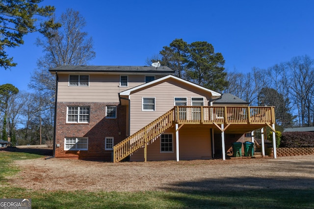 back of property with stairs, brick siding, and a deck