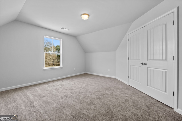 bonus room featuring lofted ceiling and carpet floors