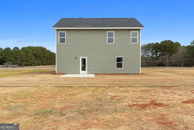 back of property featuring a lawn and a patio