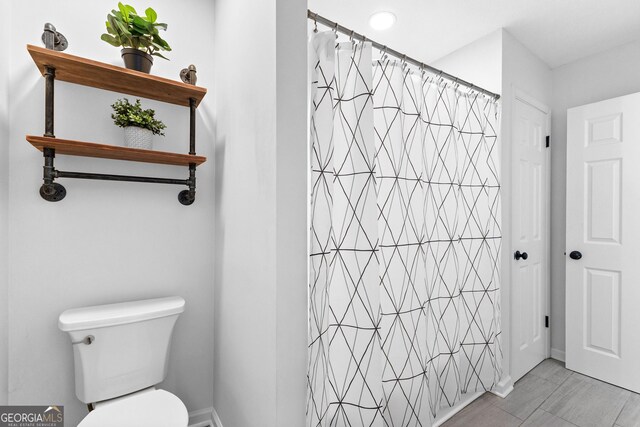 bathroom with vanity, toilet, and a shower with shower door