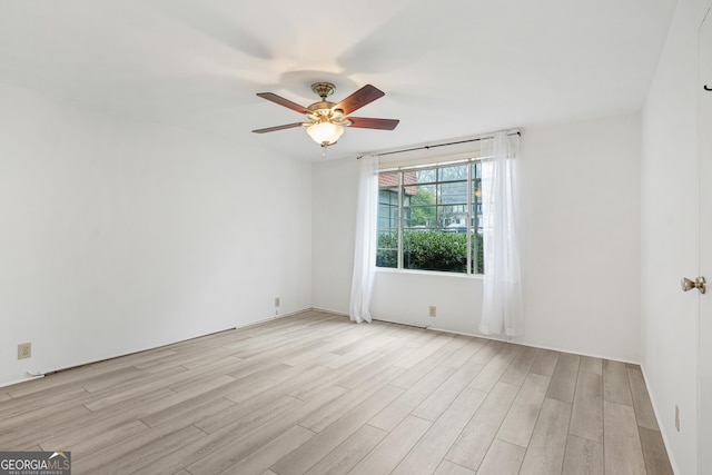 empty room with ceiling fan and light wood-type flooring