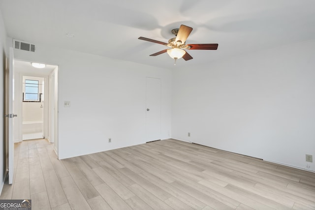 spare room featuring ceiling fan and light hardwood / wood-style floors