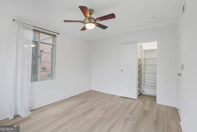 empty room featuring ceiling fan and light wood-type flooring