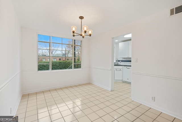 tiled empty room with a chandelier and sink