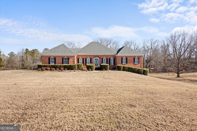 single story home featuring a front yard