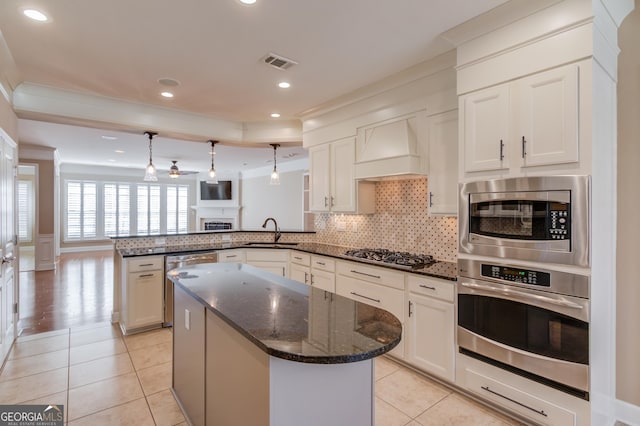 6706 Amherst Dr, Hoschton, GA 30548 - kitchen featuring appliances with stainless steel finishes, premium range hood, a peninsula, ornamental molding, and light tile patterned flooring
