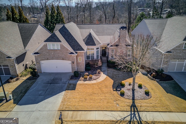 6706 Amherst Dr, Hoschton, GA 30548 - view of front of home featuring brick siding, concrete driveway, and roof with shingles