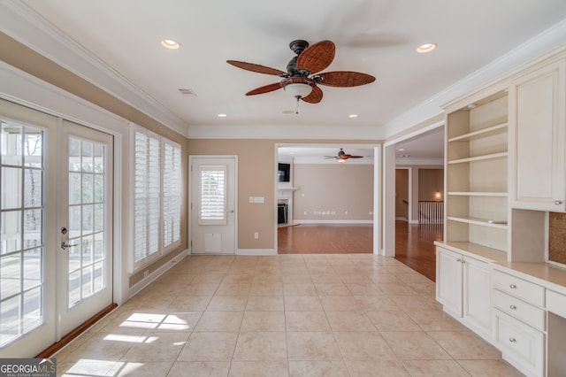 unfurnished living room featuring french doors, ceiling fan, ornamental molding, and light tile patterned floors