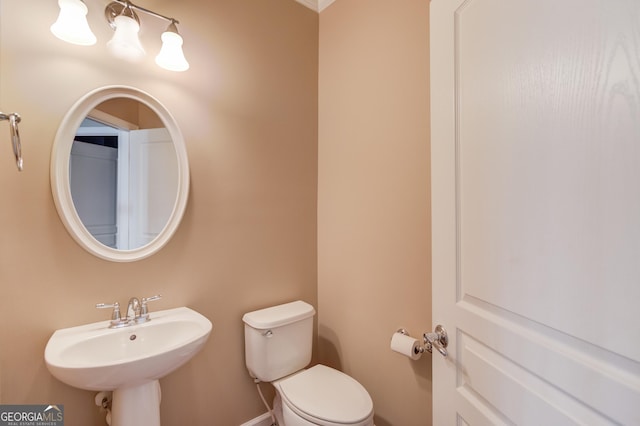 bathroom featuring toilet and sink