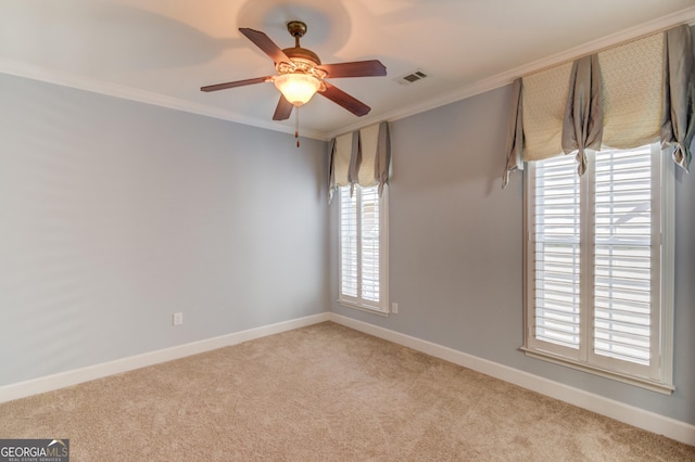 carpeted spare room featuring ceiling fan and ornamental molding