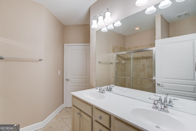6706 Amherst Dr, Hoschton, GA 30548 - bathroom featuring a shower stall, double vanity, and tile patterned floors