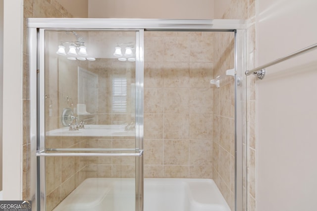 bathroom featuring a shower with door