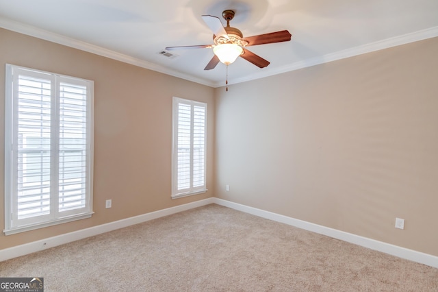 carpeted empty room featuring ornamental molding and ceiling fan