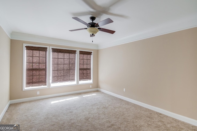 carpeted spare room featuring crown molding and ceiling fan