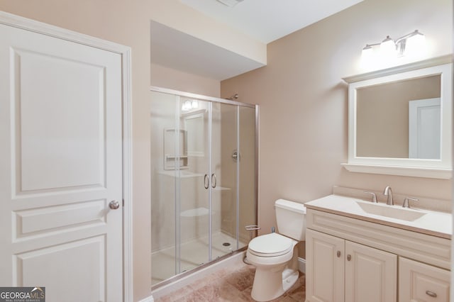 bathroom with vanity, an enclosed shower, and toilet