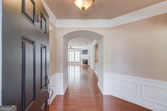 hallway featuring ornamental molding and dark hardwood / wood-style flooring