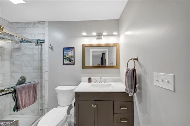 bathroom with vanity, toilet, and walk in shower