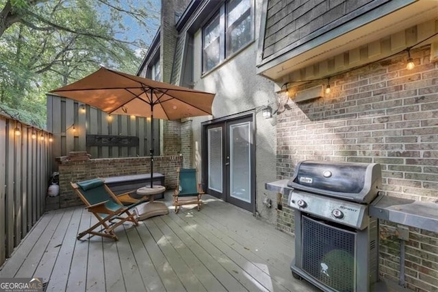 wooden deck featuring area for grilling