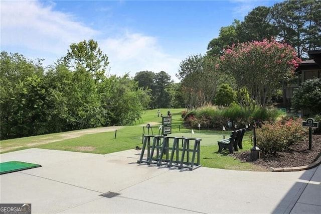 view of community with a lawn and a patio area