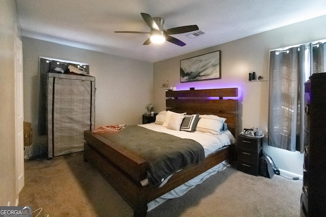 bedroom featuring ceiling fan and carpet