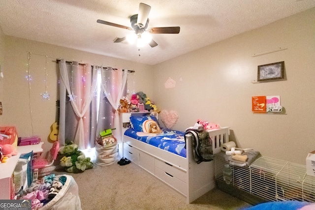 bedroom with ceiling fan, carpet flooring, and a textured ceiling