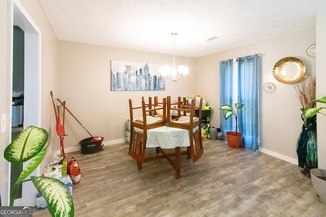 dining space featuring a chandelier and light wood-type flooring