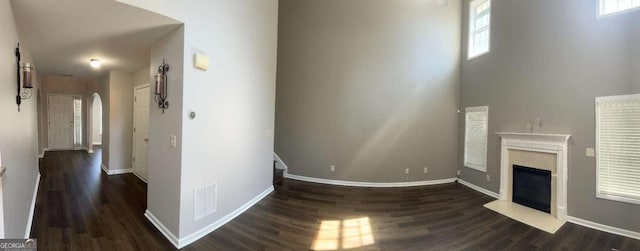 unfurnished living room featuring dark hardwood / wood-style floors