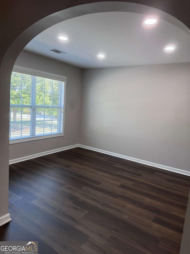 spare room with dark wood-type flooring