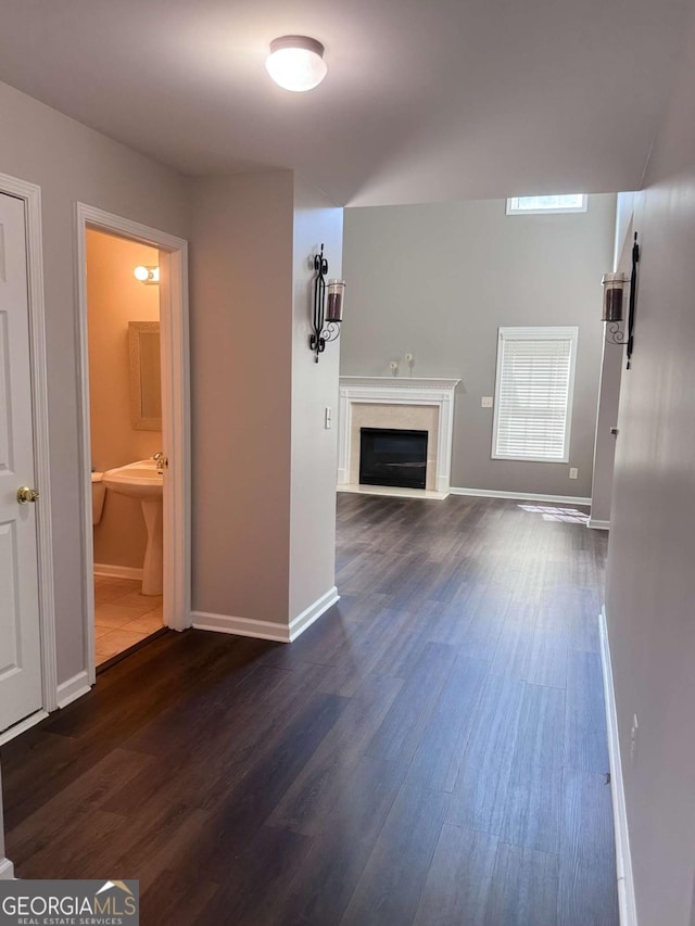 unfurnished living room featuring dark hardwood / wood-style floors and a high end fireplace