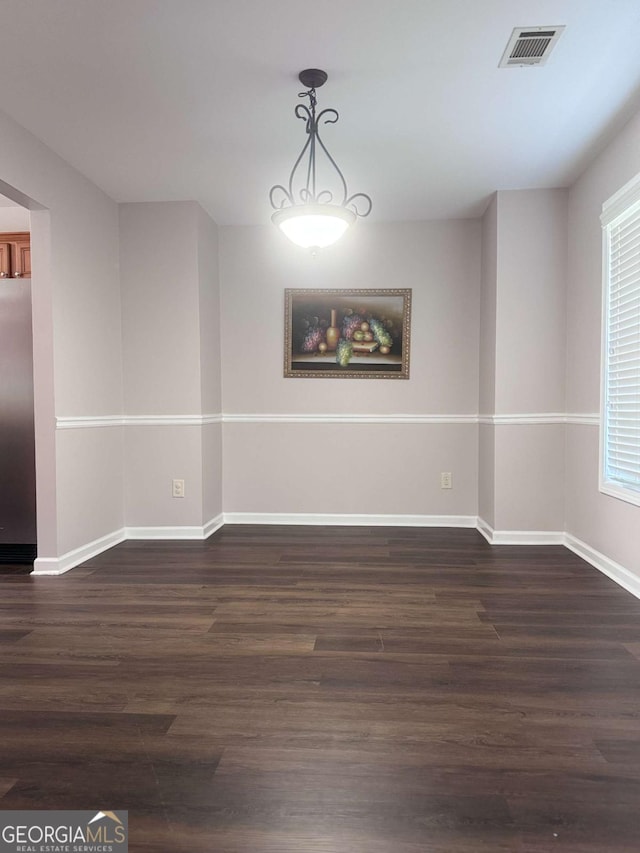 unfurnished room with dark hardwood / wood-style flooring