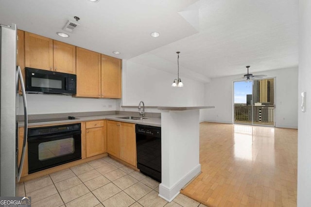 kitchen featuring sink, ceiling fan, hanging light fixtures, black appliances, and kitchen peninsula