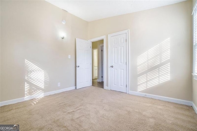 carpeted empty room with vaulted ceiling