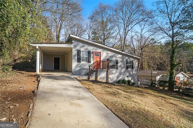 view of front of property with a carport and a front lawn